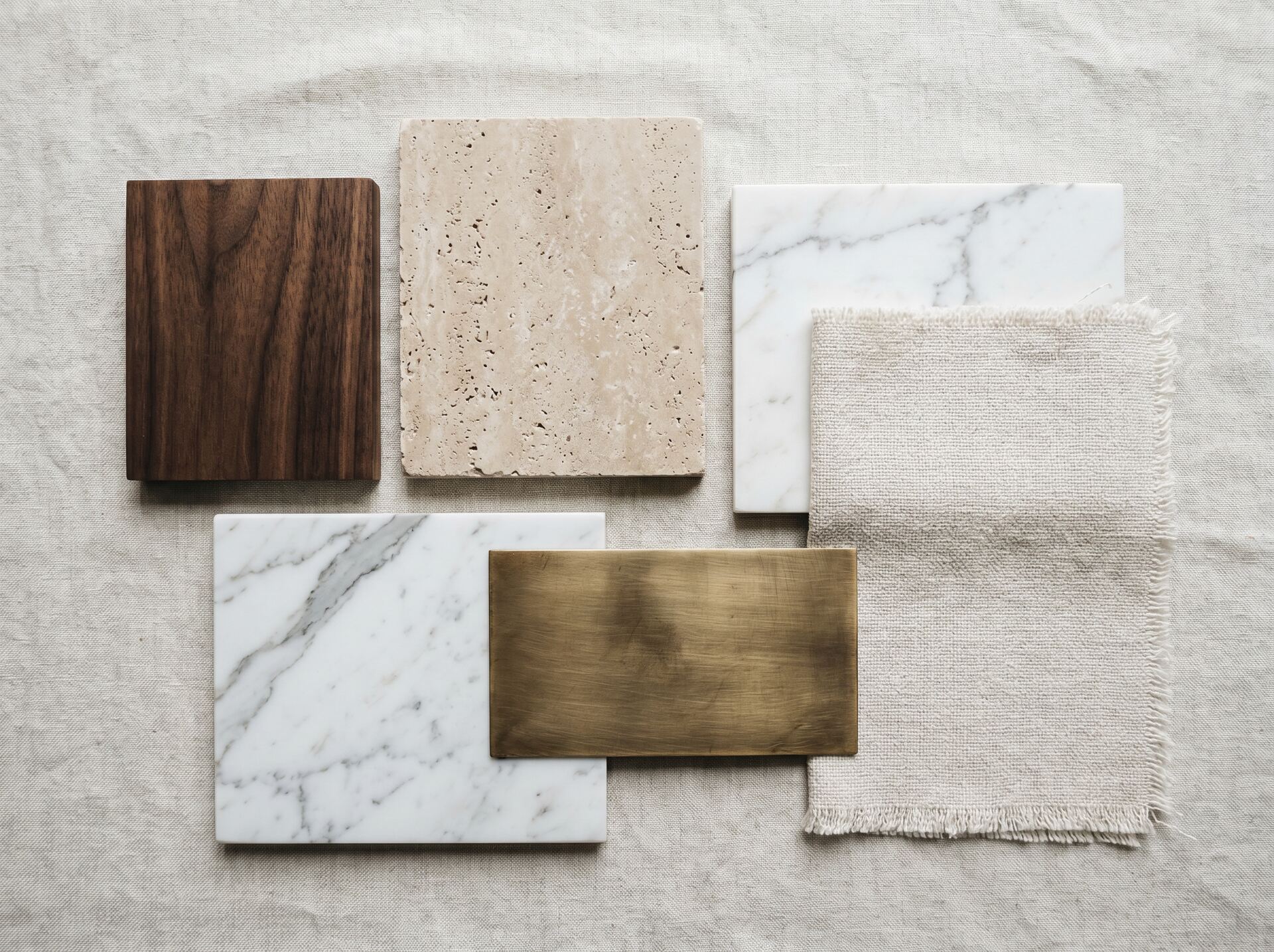 Material samples — walnut, travertine, brass, linen